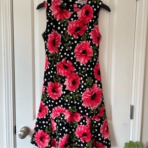 Black dress with hot pink flowers and white polka dots. Size 6.